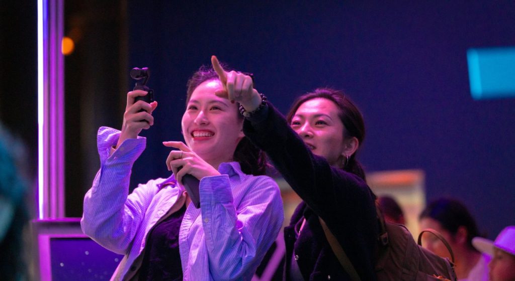 Two female guests enjoying a hands-on exhibit, taking advantage of membership benefits.