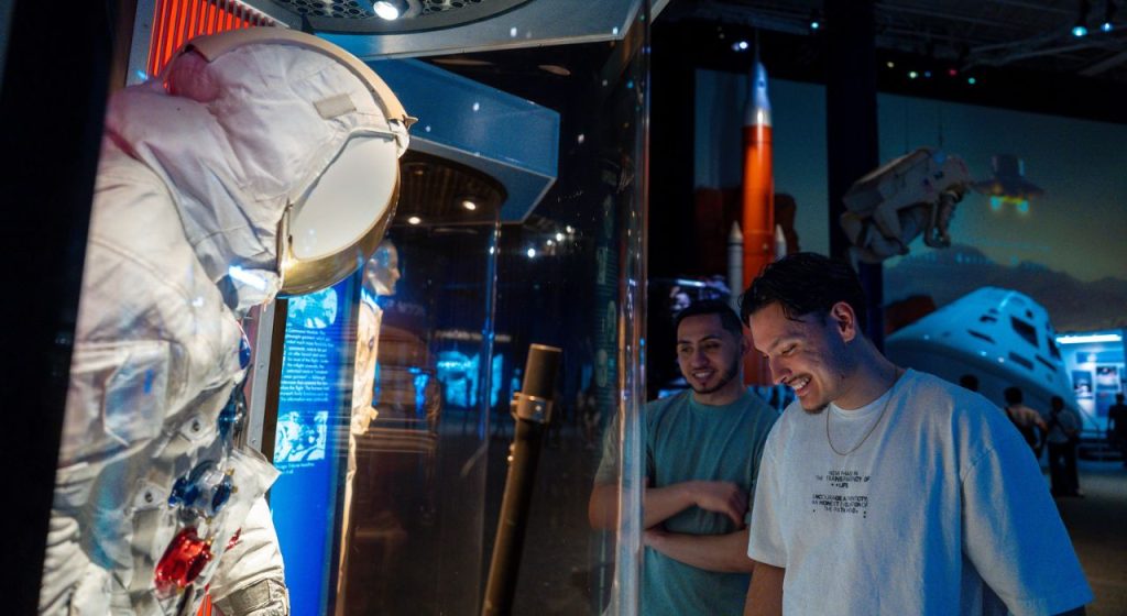 Two male guests exploring exhibits with membership benefits.