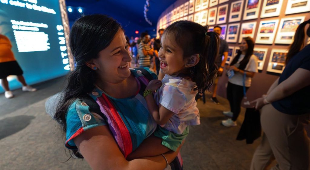 Mother and daughter enjoying membership benefits at member-only event.